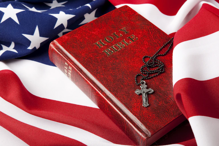 The Holy Bible lies on top of the American flag.