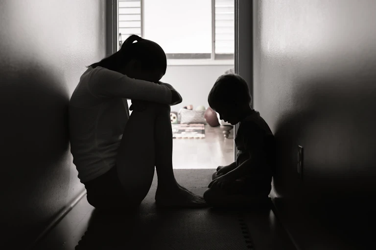 Mother and child sitting on the floor at home