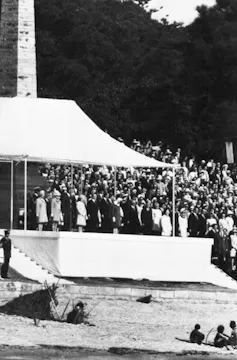 Queen Elizabeth II, fourth from left on dais, with other members of the royal family watch a re-enactment of the landing of Captain Cook in Sydney, 1970.