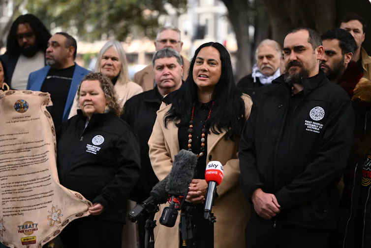 A group of people address a media conference.