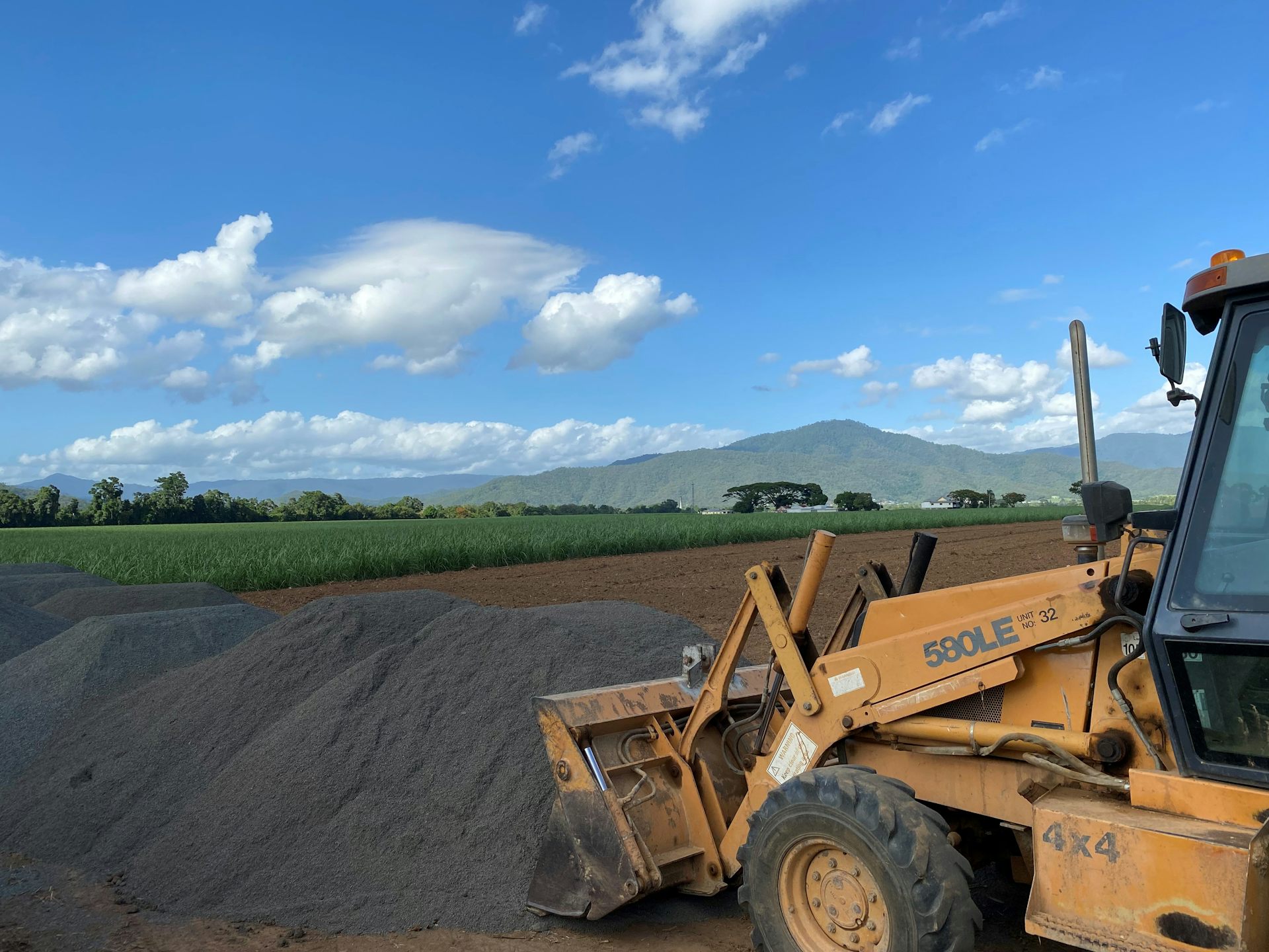 Loading crushed basalt into a spreader ready for application to trial plots on a sugarcane farm in North Queensland.