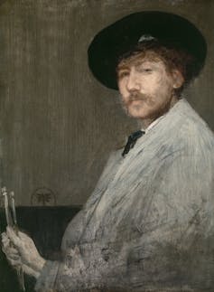 Self portrait of Whistler in artist's clothing and beret holding paint brushes
