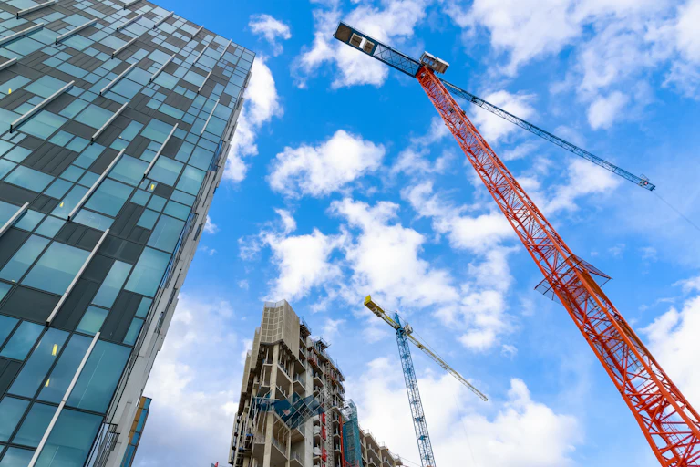 crane and construction works against a blue sky