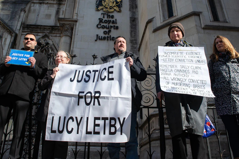 Demonstrators carrying "justice for Lucy Letby" banners outside the High Court.