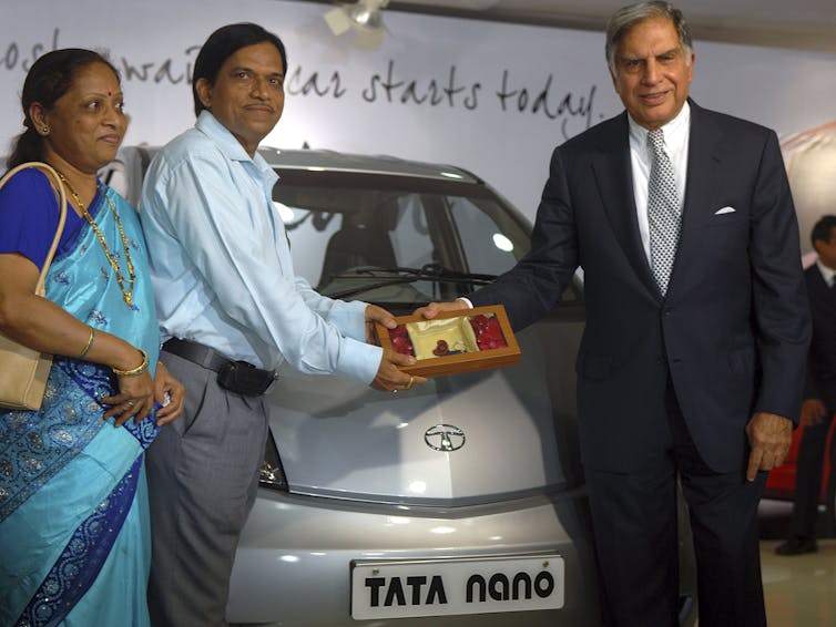 Couple being given car keys.
