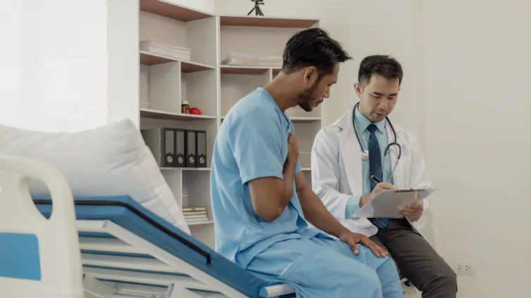 male hospital patient talking to a doctor