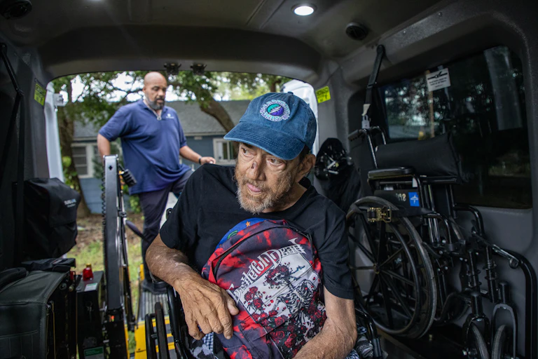A man in a wheelchair waits for assistance in a specially equipped van ahead of Hurricane Milton's arrival in Florida.