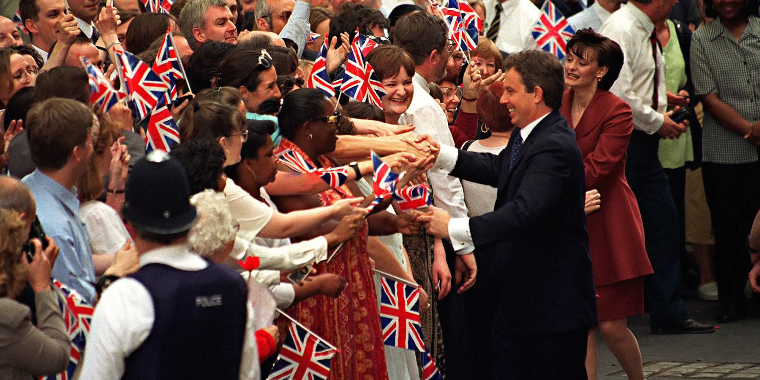 Tony and Cherie Blair shake hands of supportes outside Downing Street.