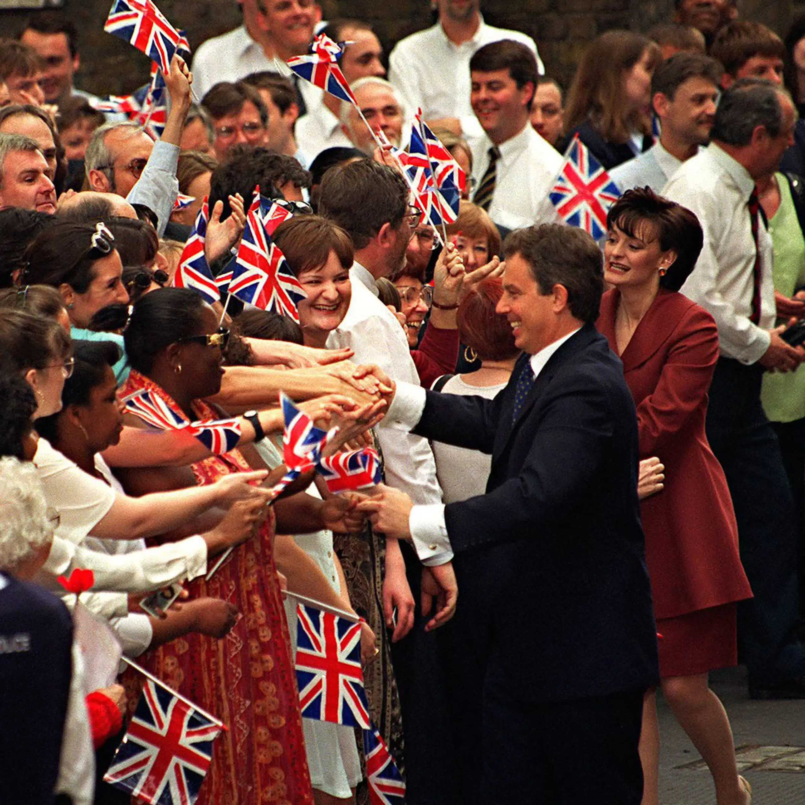 Tony and Cherie Blair shake hands of supportes outside Downing Street.
