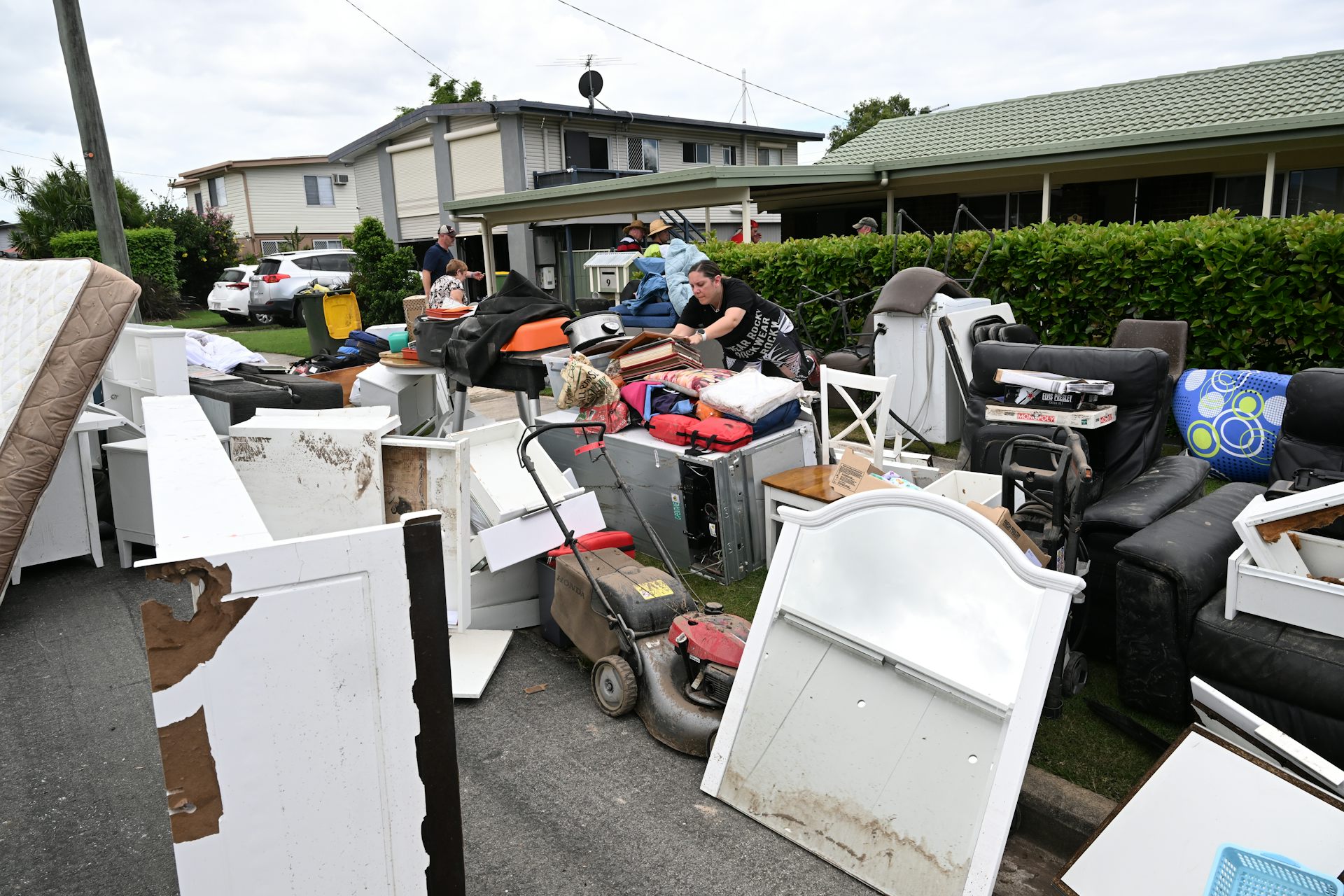 Residents put damaged property out on the street after being flooded