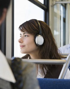 Woman listening to music on train