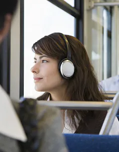 Woman listening to music on train
