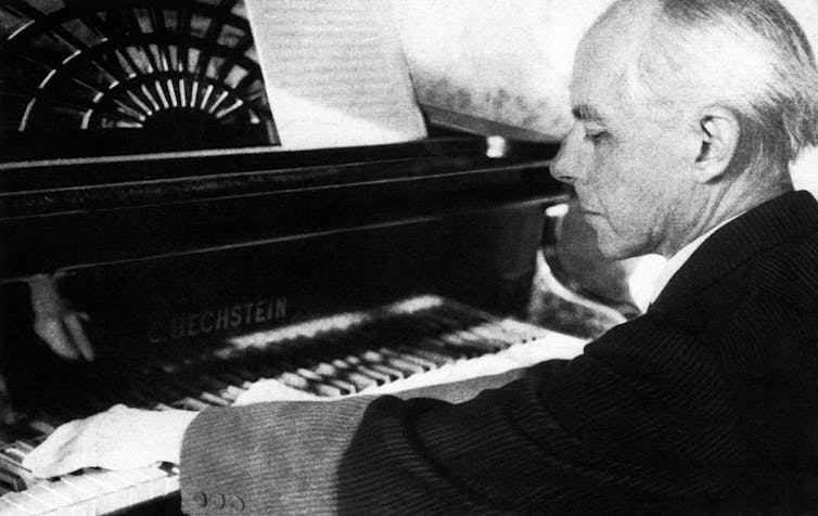 An older man at a piano.