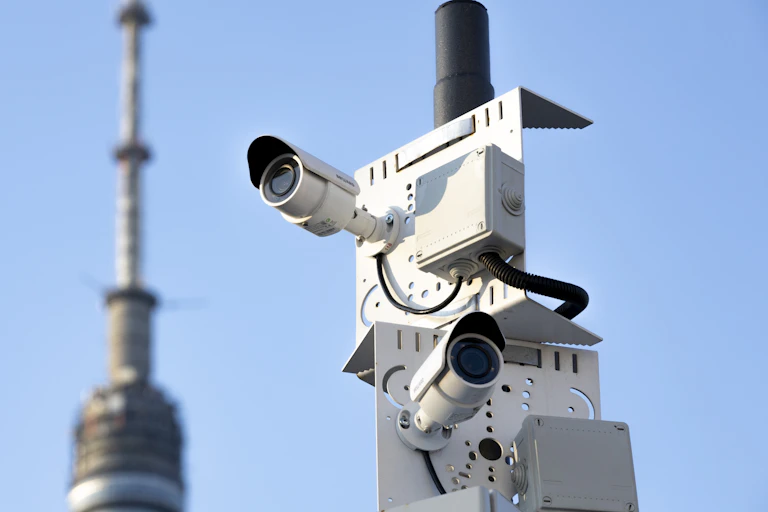 Two security cameras on a pole