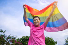 A youth with a pride flag.