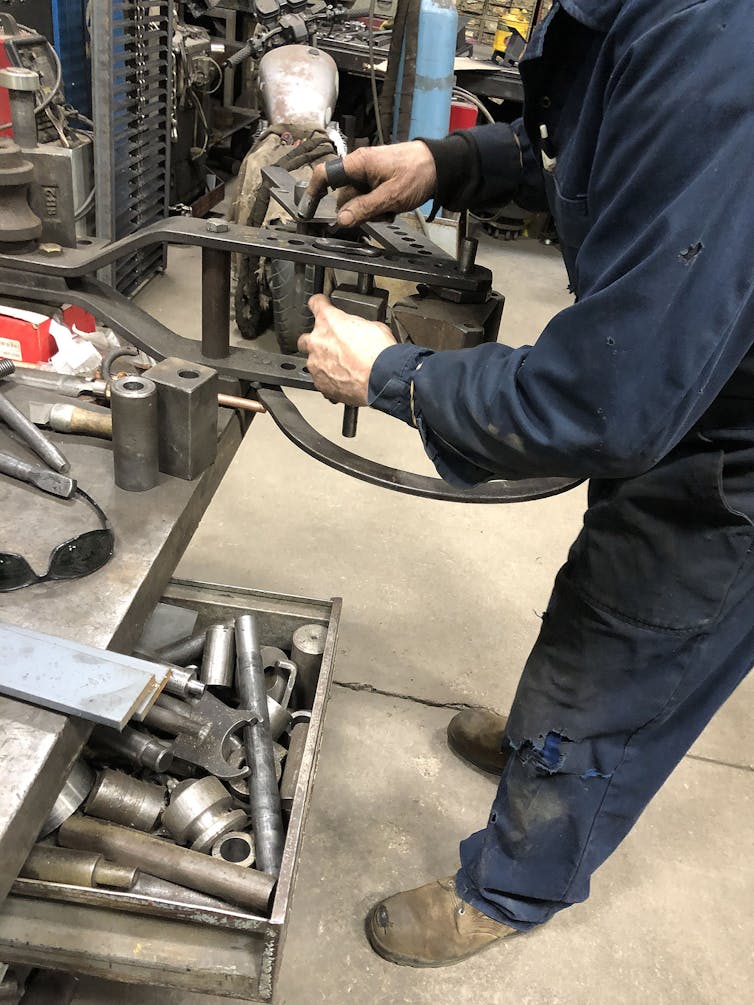 A man using a Hossfeld bender.