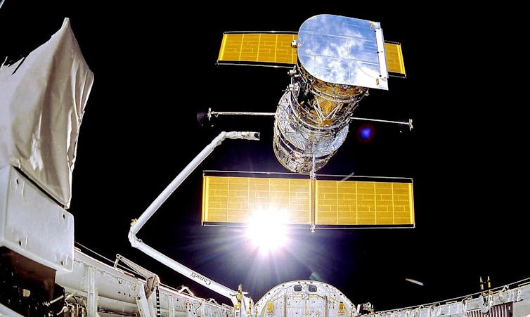 The Hubble Space Telescope being deployed from the space shuttle on 25 April 1990.