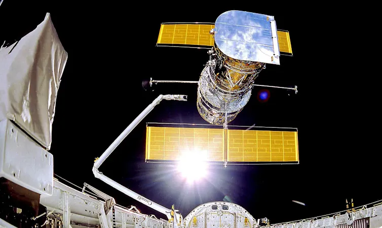 The Hubble Space Telescope being deployed from the space shuttle on 25 April 1990.