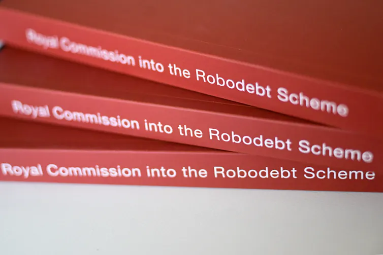 A close-up on three copies of the Royal Commission into the Robodebt Scheme