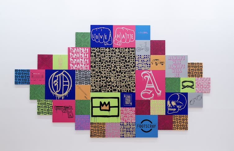 artwork shows patchwork of vibrant squares with writing and imagery on each