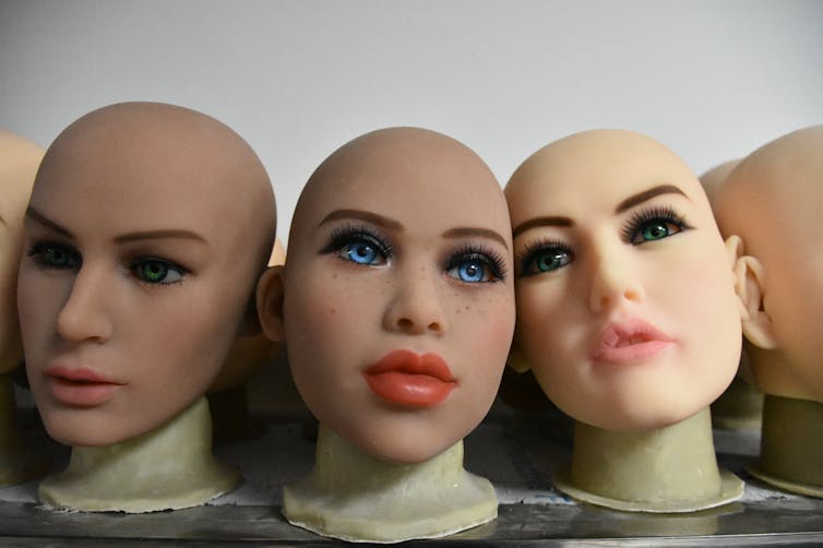 Photo of mannequin heads painted with makeup