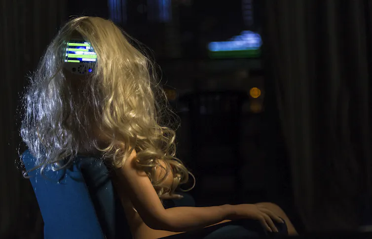 Photo of a woman-like mannequin with a screen in the back of its head