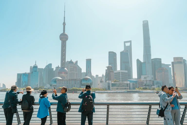 Tourists in front of the Shanghai skyline