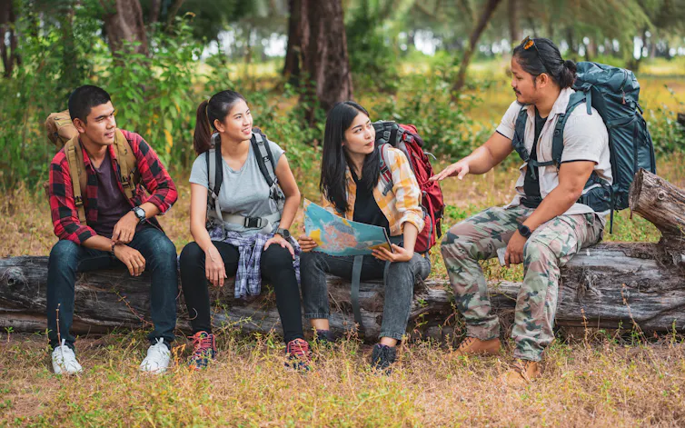 Men and women discussing a map.