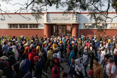Hundreds of people march outside a municipal building in Swellendam, South Africa.