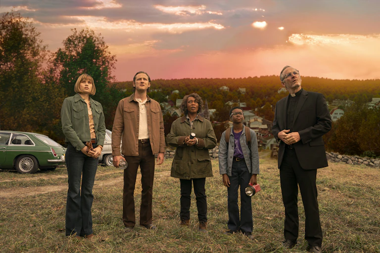 Four adults and a child looking up at something off camera