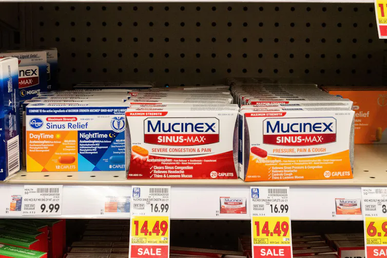 Boxes of Mucinex on a shelf in a pharmacy in the US.