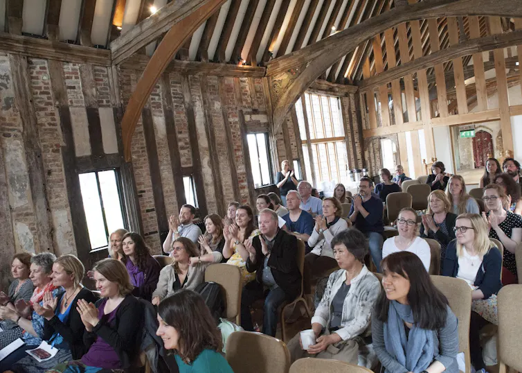 Han Kang in an audience seated in a medieval hall
