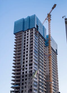 Unfinished skyscraper covered in scaffolding