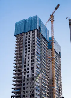 Unfinished skyscraper covered in scaffolding