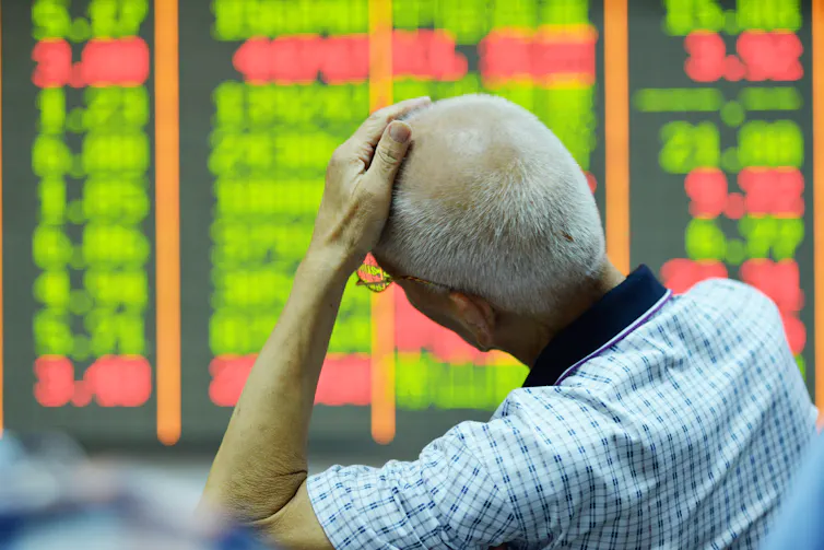 A Chinese investor looks at prices of shares