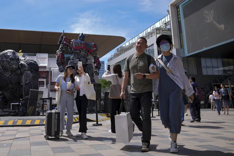 Shoppers walking in an outdoor mall in China