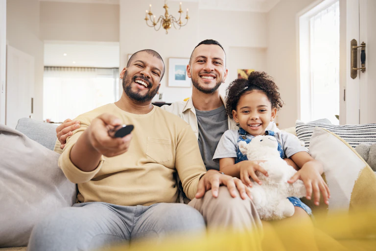 Fathers and daughter watching TV