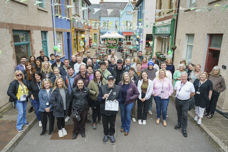 A large group of people on the Pobol y Cwm film set.