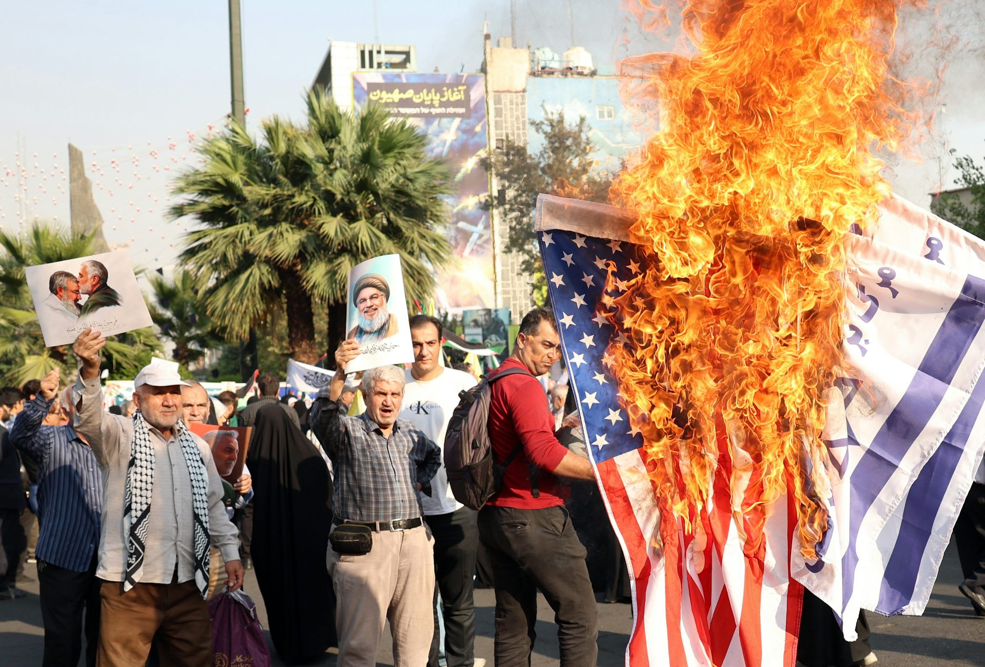 Protesters burn US and Israeli flags to register their protetst at Israel's invasion of Lebanon, October 2024.