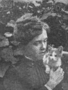 Grainy black and white photograph of a young woman cuddling with a kitten.