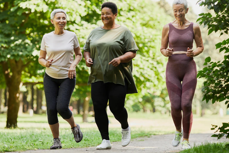 Three women running in a park