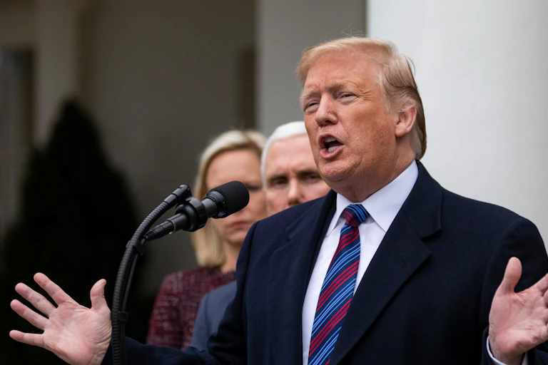 Donald Trump with his hands stretched out.