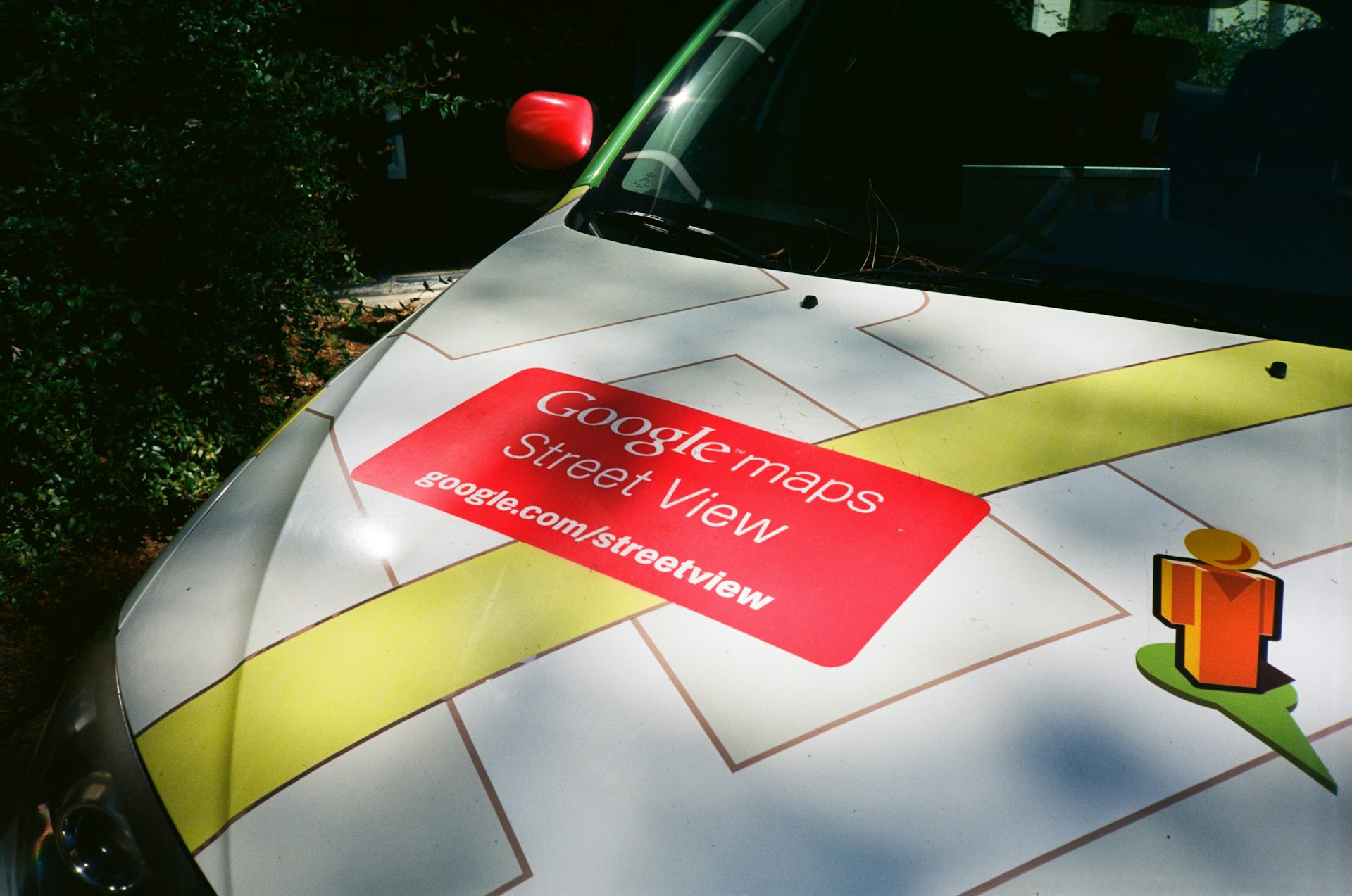 Detail view of logo for Google Streetview on hood of streetview car