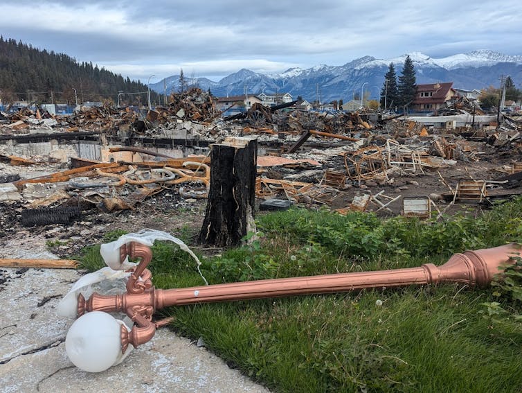a copper streetlamp lies on the ground