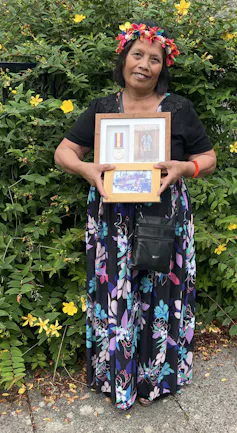 Woman holding her father's framed medal.