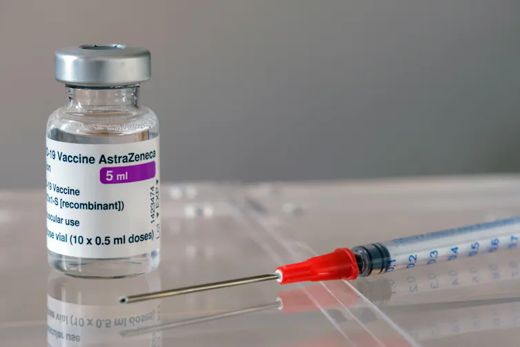An ampoule of AstraZeneca vaccine with a syringe.