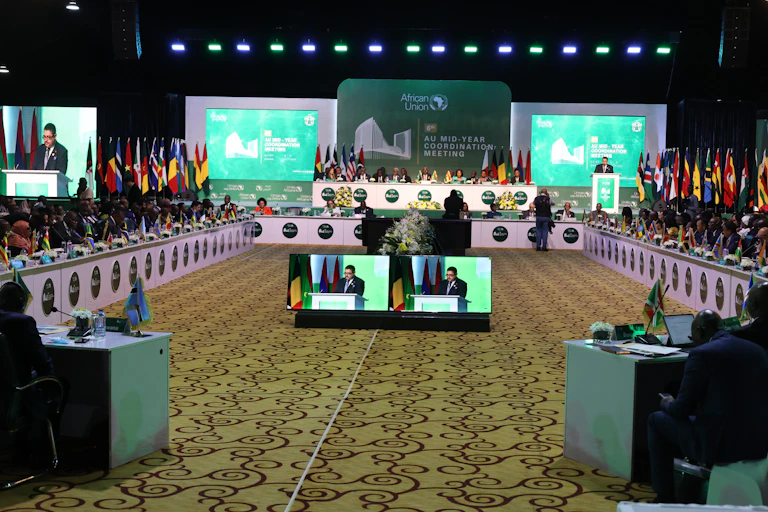 A group of people seated round a large conference table