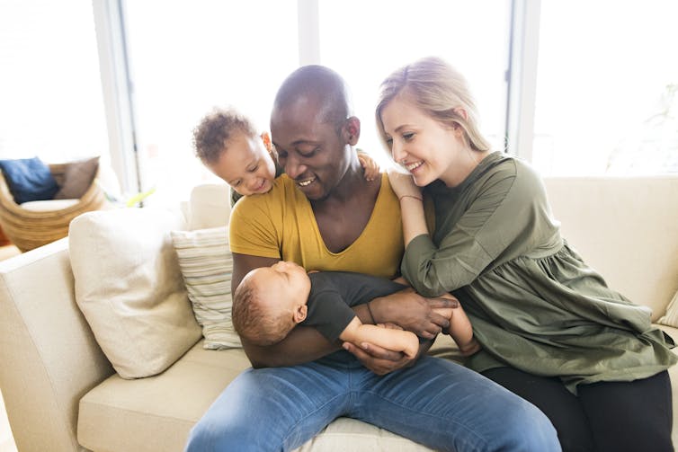 Parents and children on a couch.