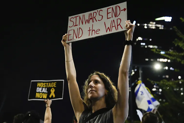 Una manifestante israelí sostiene una pancarta en la que se lee fin de la guerra