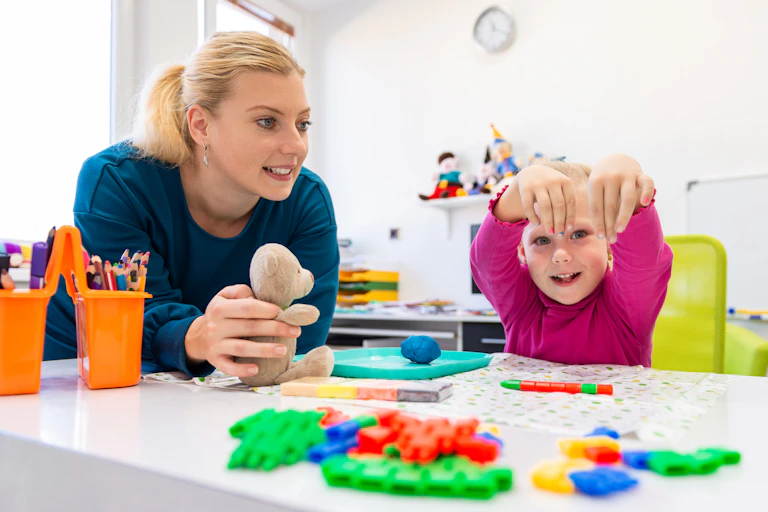 Neurodivergent girl plays with her OT